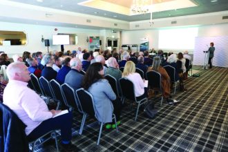 Fishermen industry conference with audience and speaker in a hotel conference room.