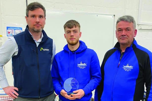 Trainee deckhand receiving award at Scottish Maritime Academy, commercial fishing industry event, in.