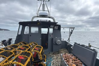 Fishing vessel with gear and catches on deck, commercial fishing industry publication.