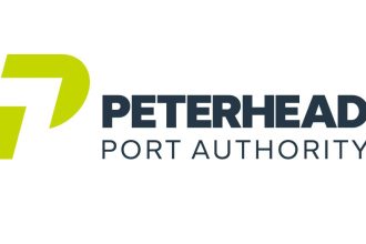 Commercial fishing vessels at Peterhead port, industry equipment and gear visible in the scene.