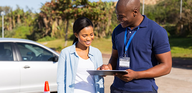 Instructor teaching student in drivers ed course