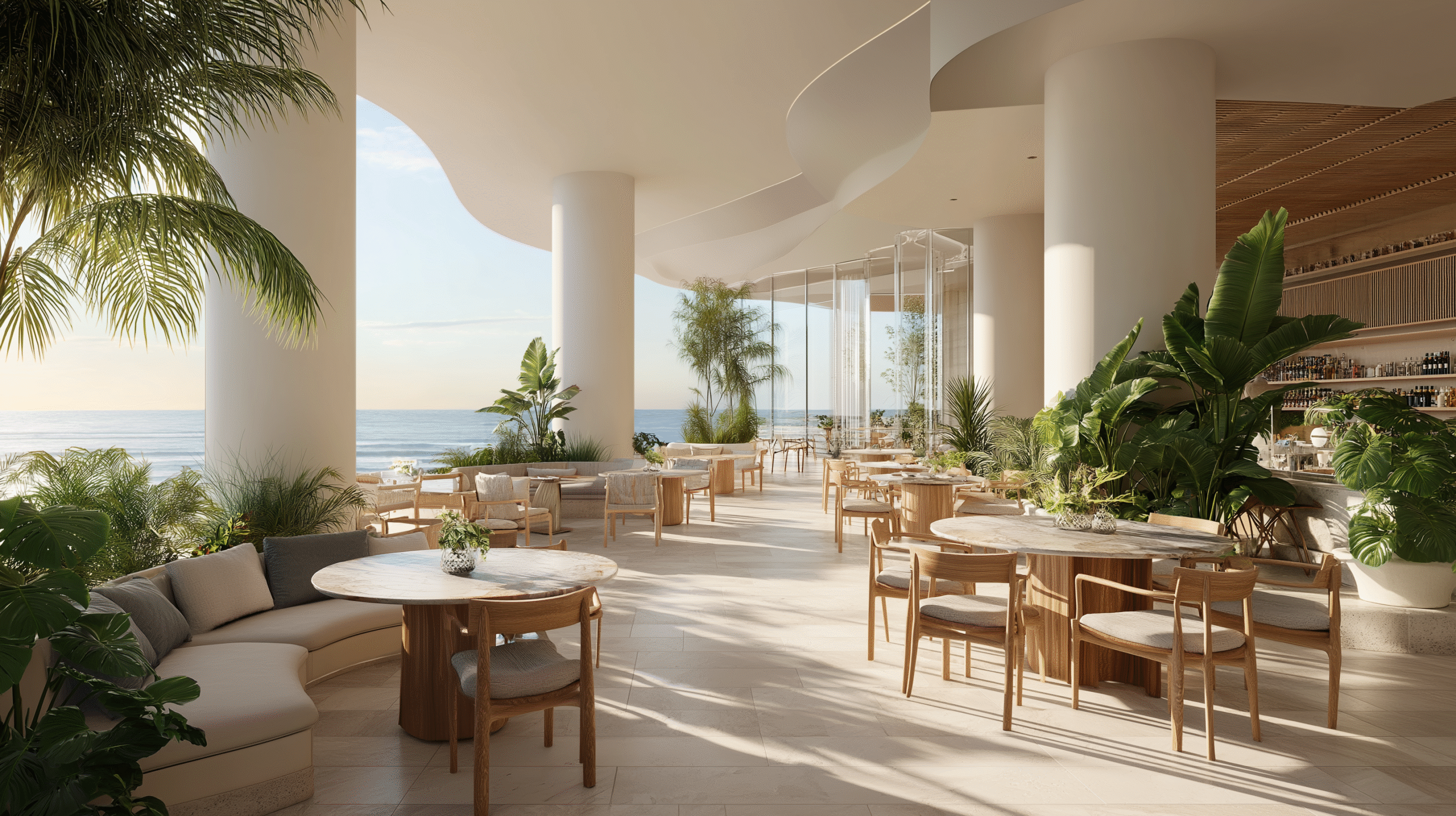 Outdoor restaurant with ocean view, modern design, and lush greenery.