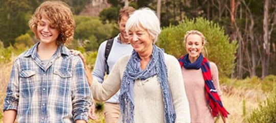 Group of diverse smiling people enjoying outdoor community event.