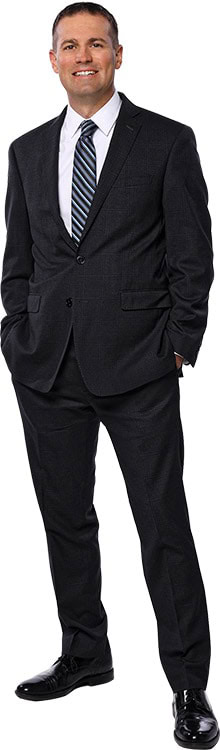 Confident businessman in formal suit smiling at camera.