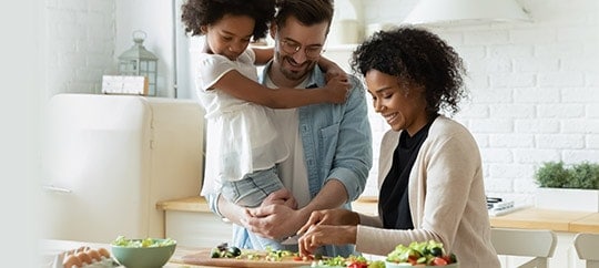 Family preparing a healthy meal in a modern kitchen.