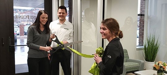 Trust Point team celebrating grand opening with ribbon cutting event.