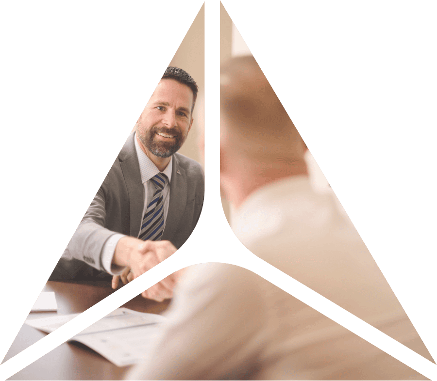 triangle shape of image of two people shaking hands while sitting at a table