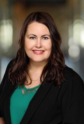 Professional portrait of a woman in business attire at Trust Point.