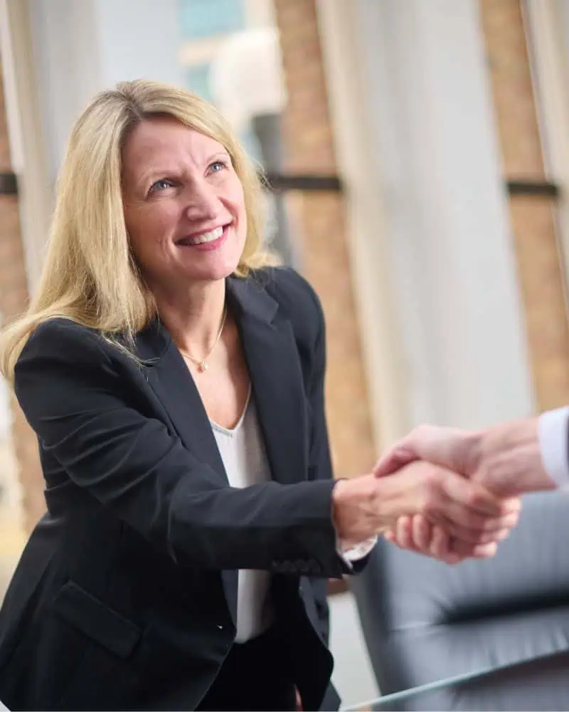 Business professional shaking a client's hand
