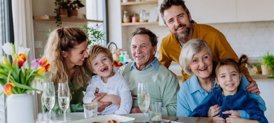 Happy multigenerational family enjoying a meal together in the kitchen.