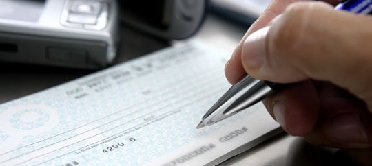 person writing out a check