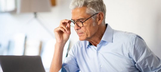 Older Man Looking At Computer With glasses