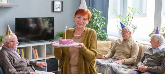 Woman holding a cake celebrating her birthday