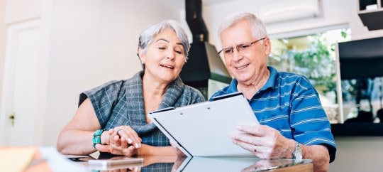 Elderly couple reviewing papers