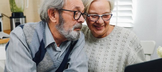 Man and woman looking at a computer