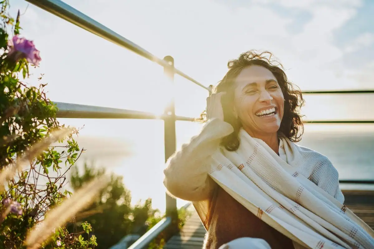 Woman smiling with the sun shining
