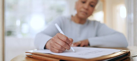 Woman writing in padfolio