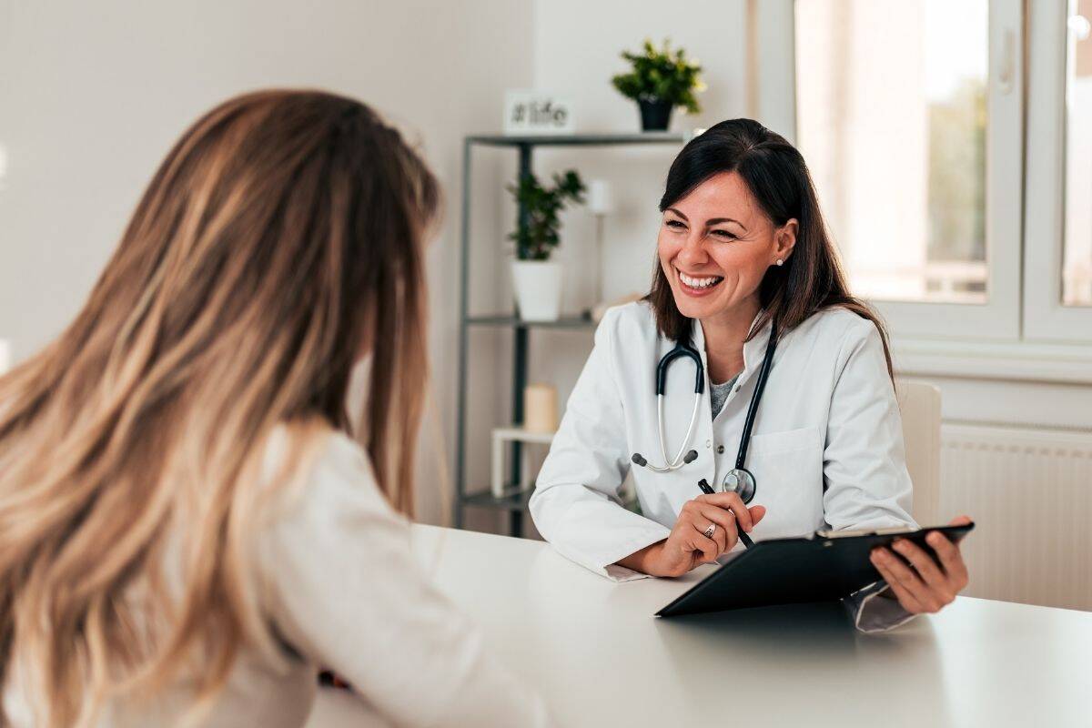 Woman physician speaking to another woman