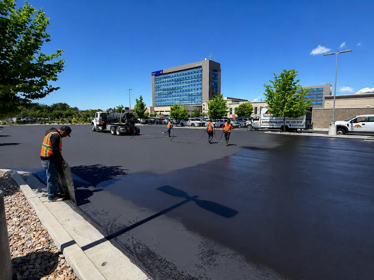 Eckles Paving crew applying sealcoating to a commercial parking lot in Utah