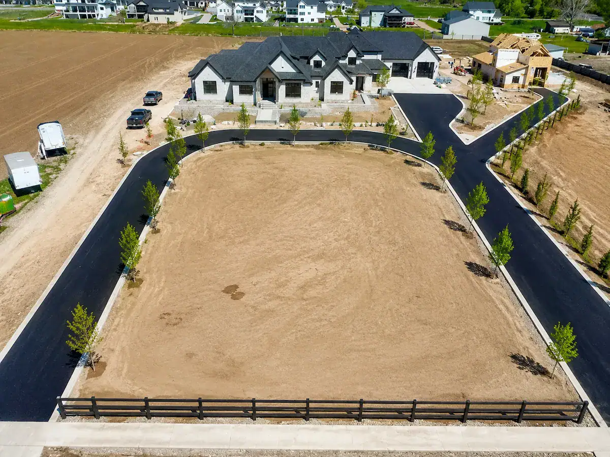 Aerial drone view of luxury estate with custom asphalt driveway in Utah