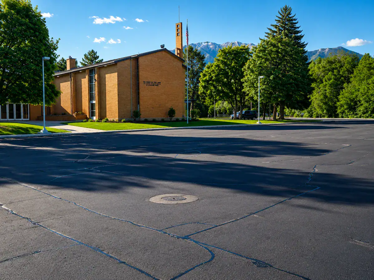 Church parking lot in Utah with professional asphalt crack sealing and mountain views in the background