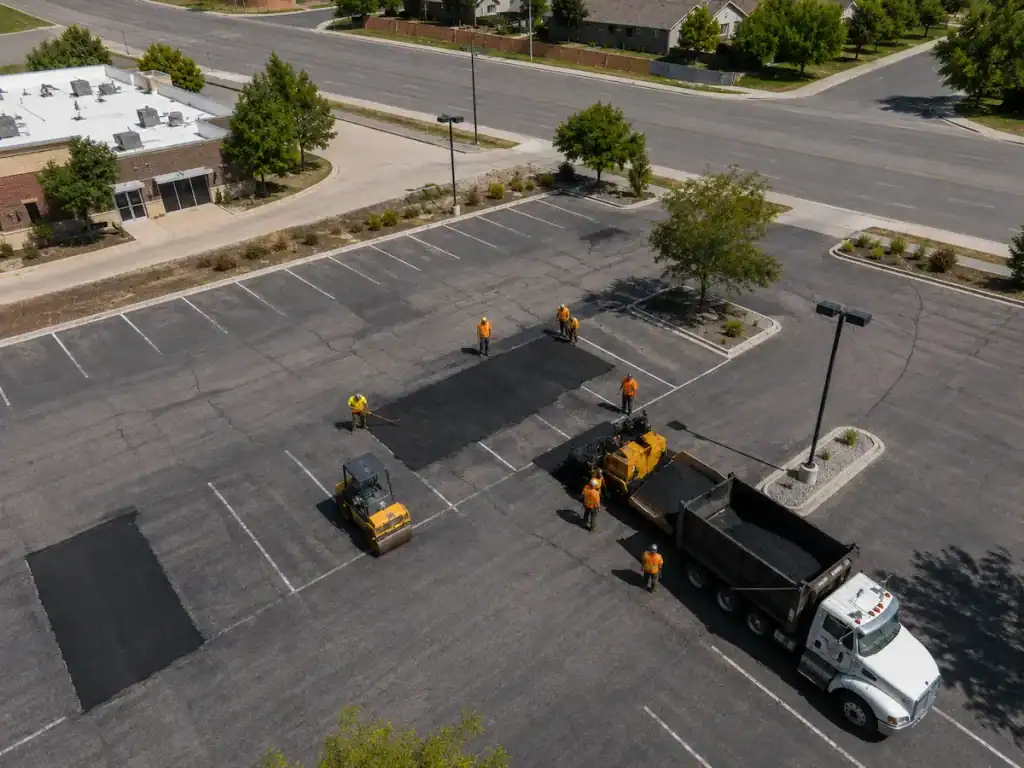 Aerial drone view of a commercial asphalt patching project in a Utah parking lot