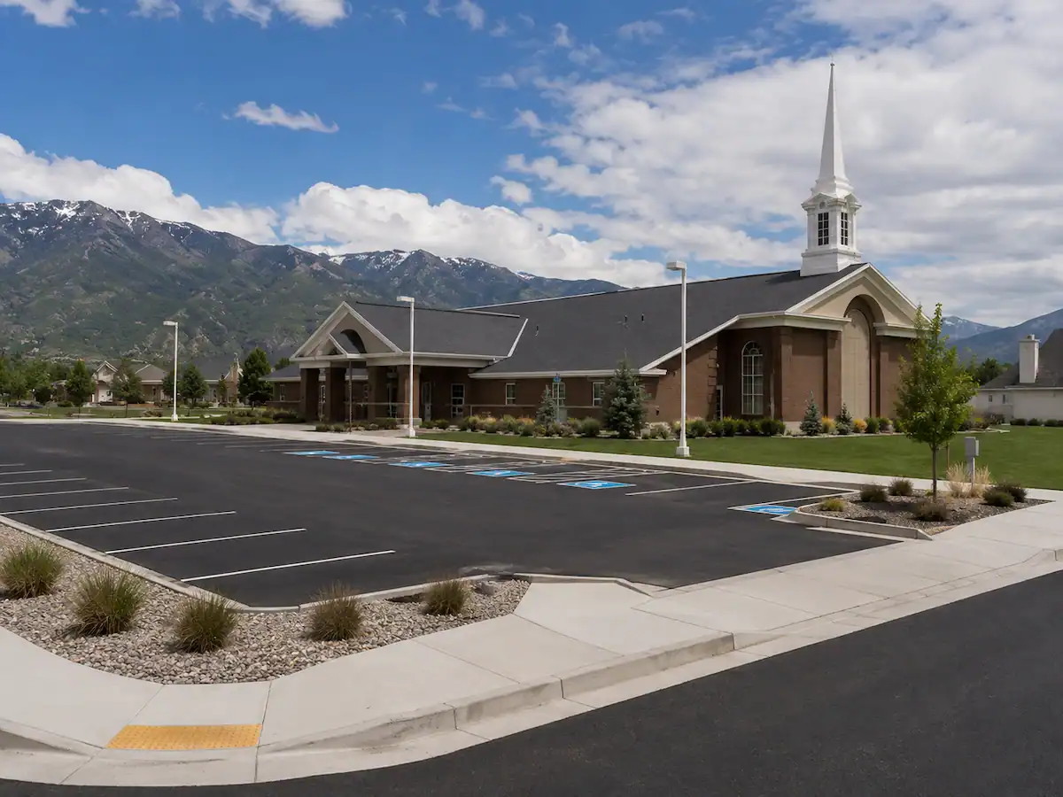 LDS church in Utah featuring fresh asphalt paving, concrete sidewalks, curbs, and ADA-accessible parking areas.