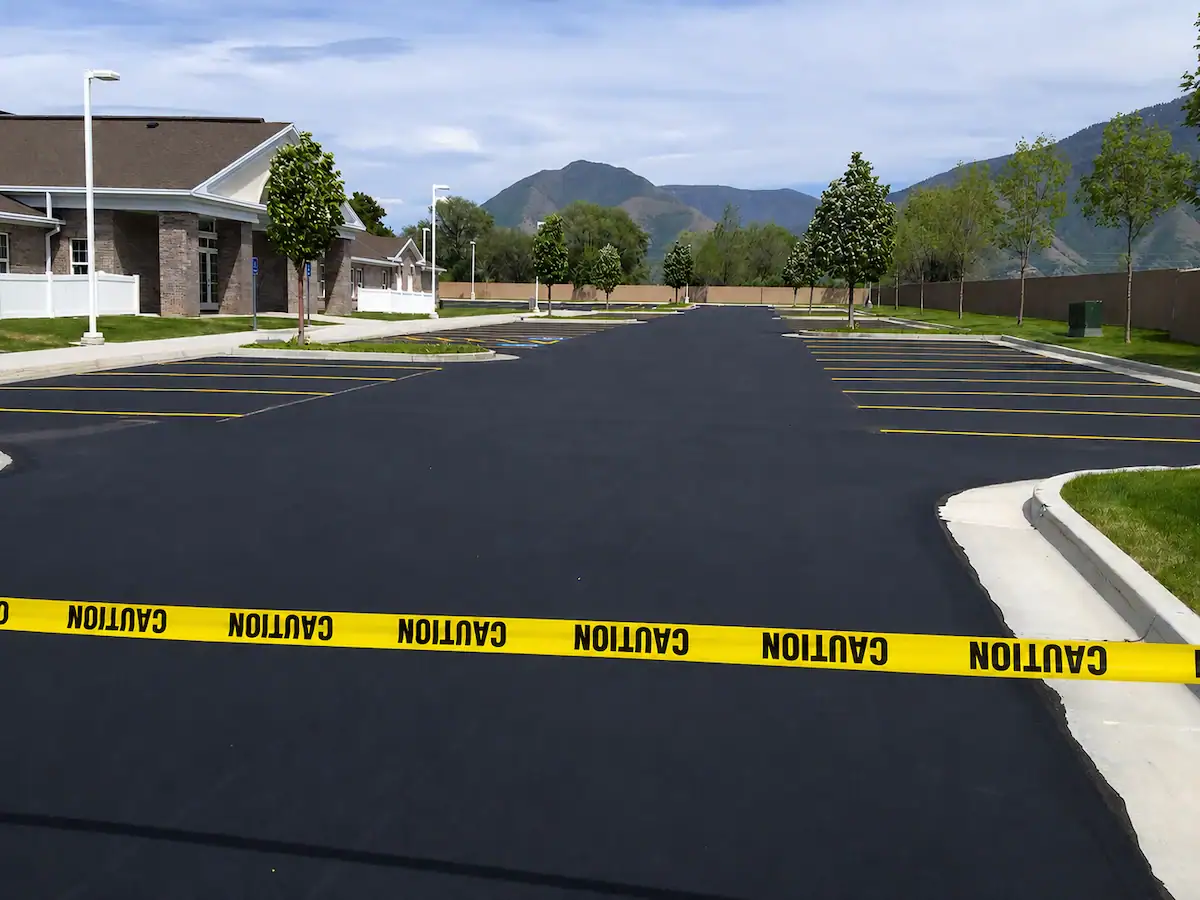 Freshly sealcoated parking lot with new striping and mountain backdrop in Utah