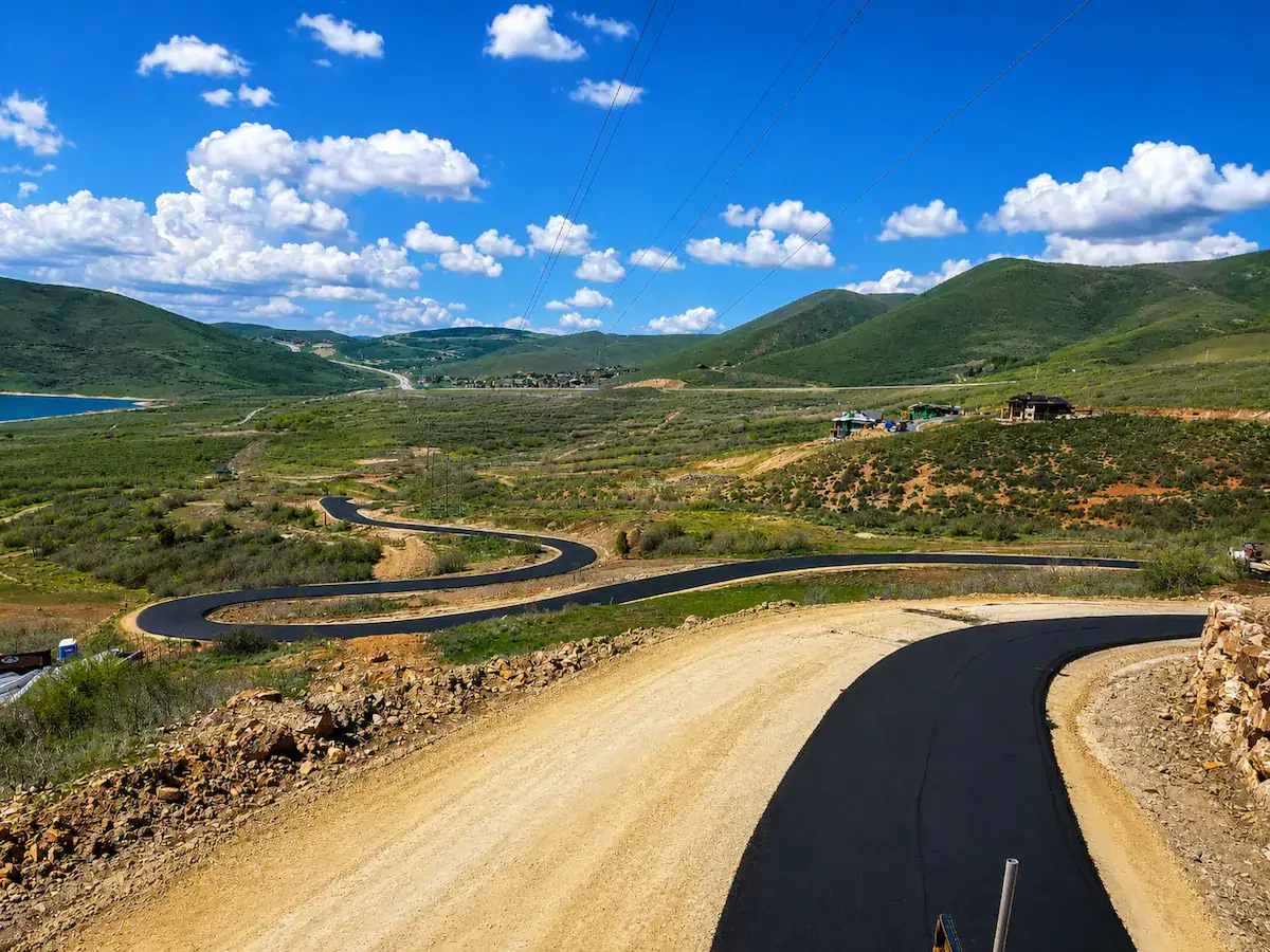 New winding asphalt road paving project through Utah mountain landscape