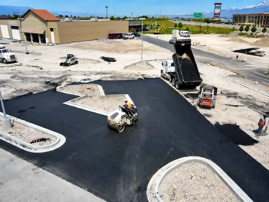 Commercial asphalt paving project in Utah with paving crew installing new parking lot pavement