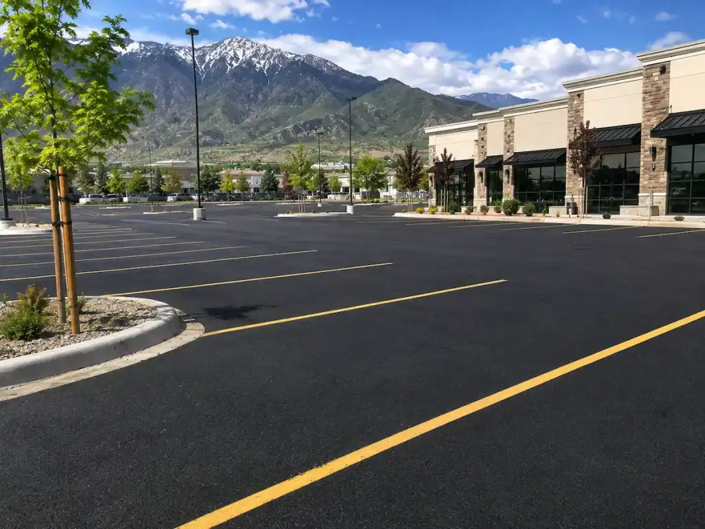 Freshly paved commercial parking lot in Utah with new asphalt and parking lot striping.