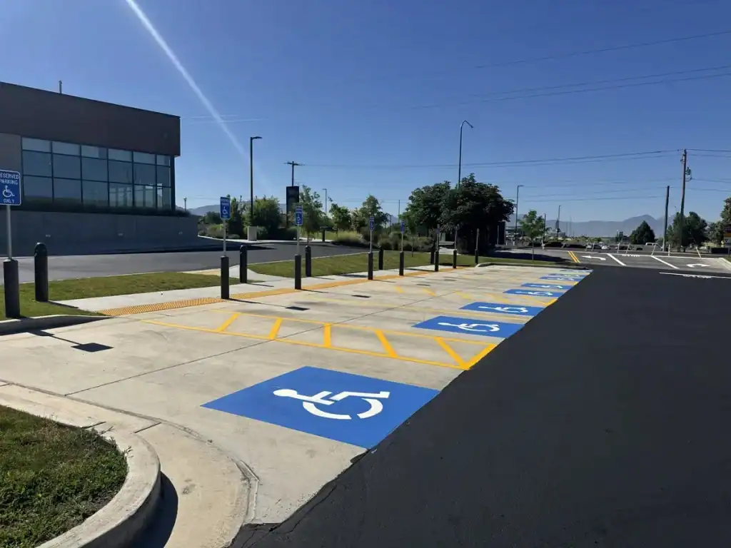 Freshly striped accessible parking spaces on newly sealcoated asphalt at Utah Valley University in Orem, Utah.