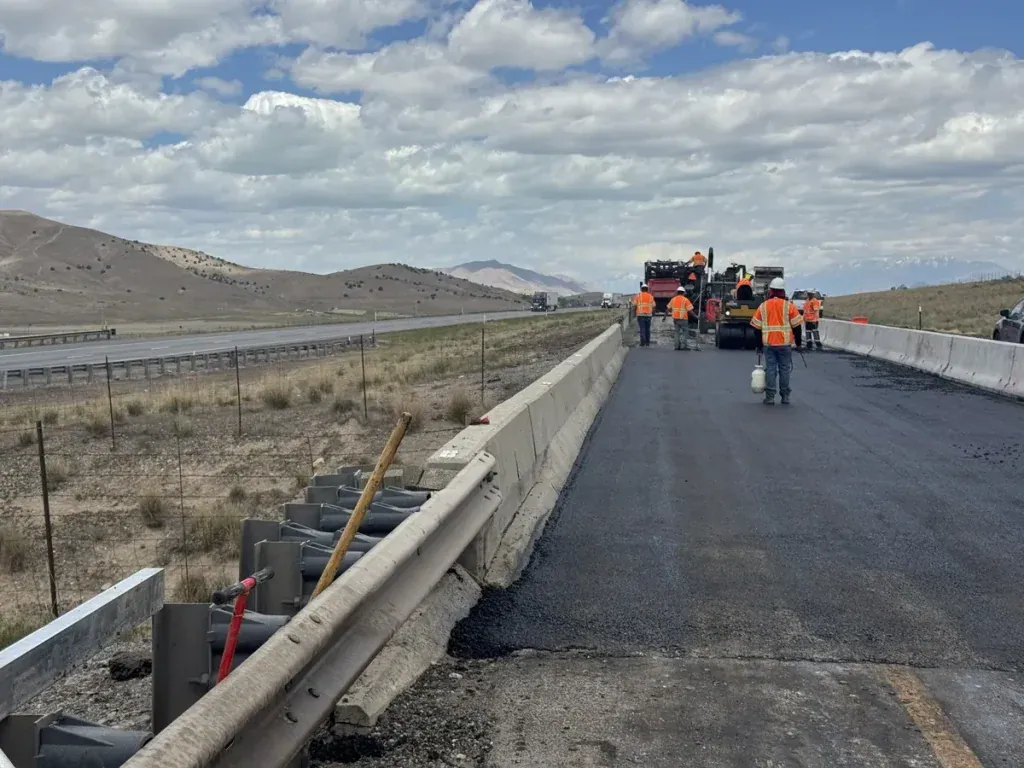 Eckles Paving crew installing new asphalt along I-15 in Mona, Utah, during a highway paving project.