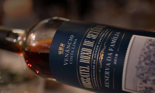 Garrafa de vinho Moscatel Roxo Venâncio da Costa Lima com rótulo premium detalhado.