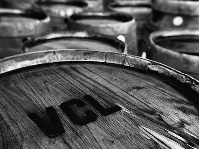 Borbulhas de vinho envelhecido em barris de carvalho no vinhedo Venâncio da Costa Lima, destacando a tradição e qualidade na produção de vinhos complementada por tratamentos artesanais.