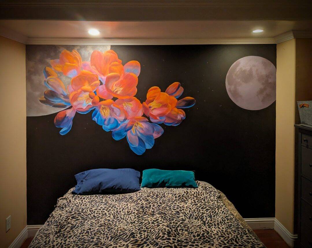 Imaginative bedroom mural art of vibrant flowers in outer space.