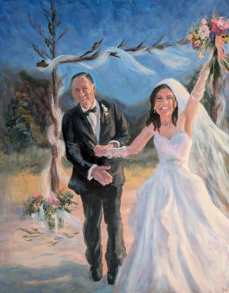 A couple leaves their wedding arch with big smiles and celebratory arms raised