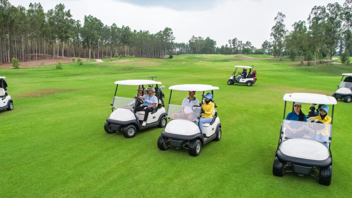A number of Golf buggies on a golf course