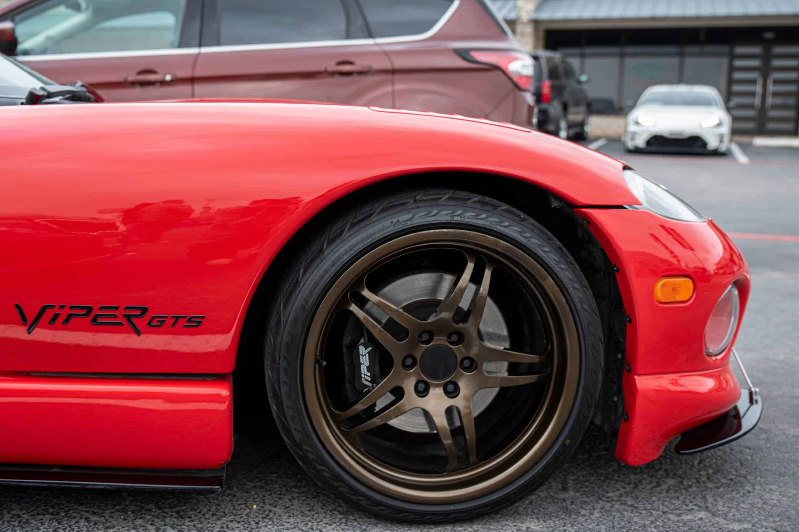 front rim of a 1990s dodge viper in red.