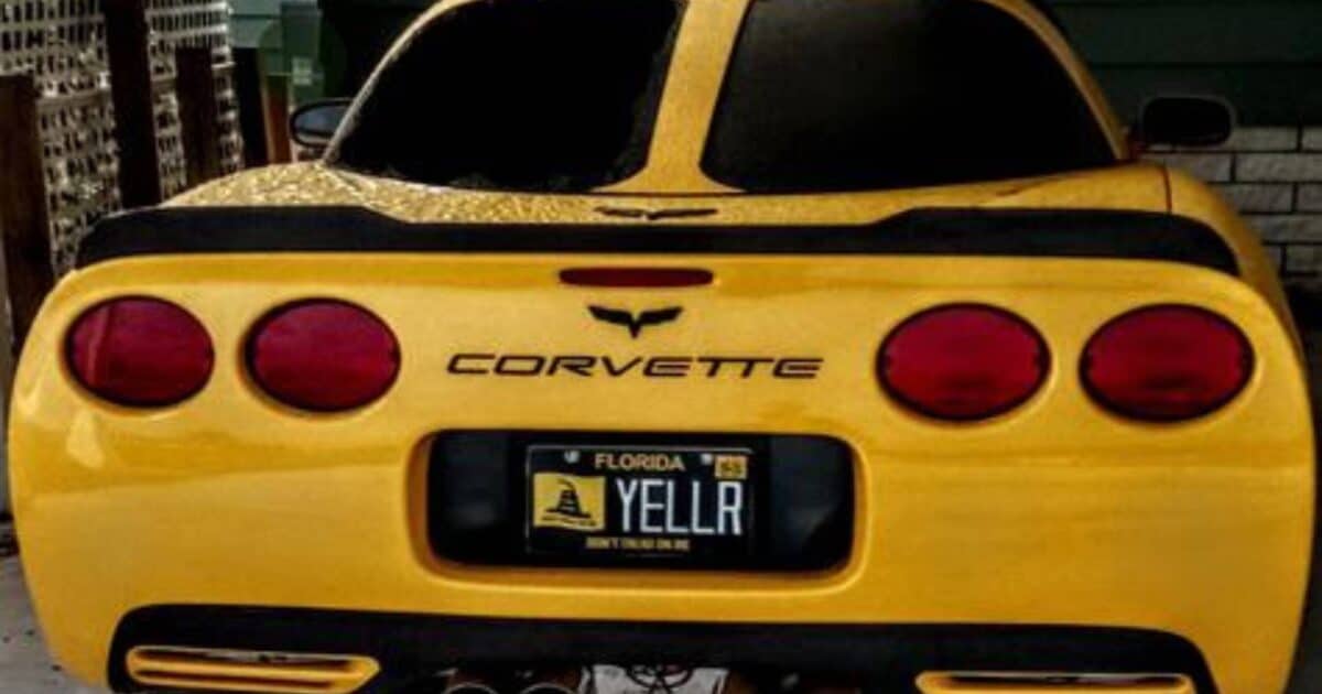 Yellow chevrolet corvette with custom license plate