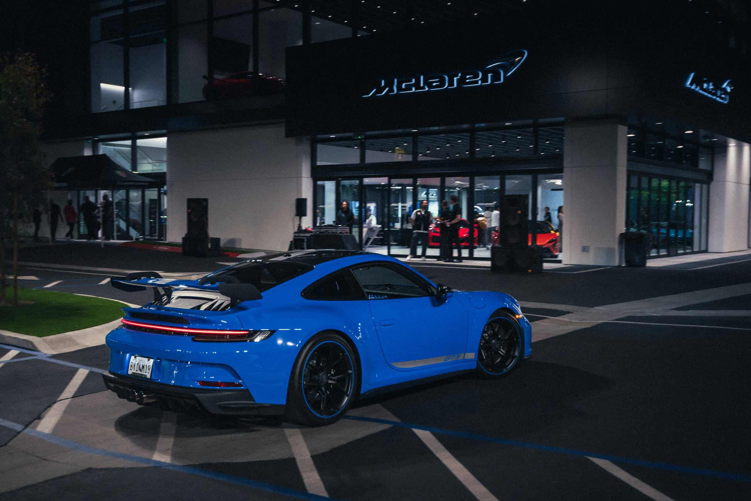 Blue porsche 911 outside of dealership