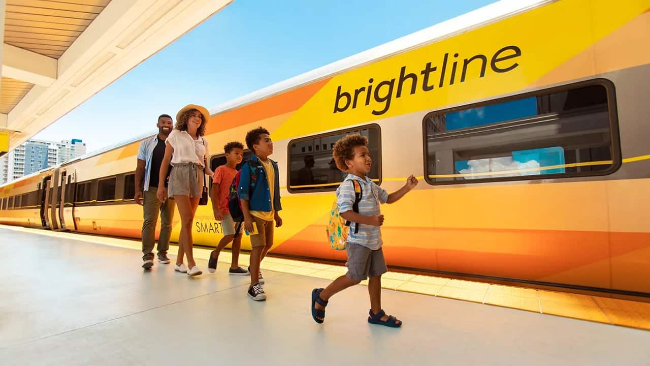 Family pictured in front of a Brightline train
