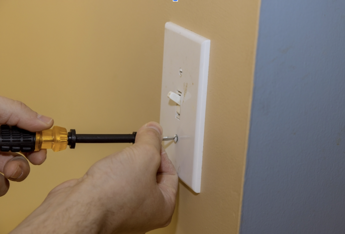 electrician installing light switch in minnesota.