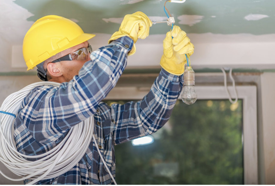 Local Electrician Accredited Electric repairing a light fixture in Minnesota home