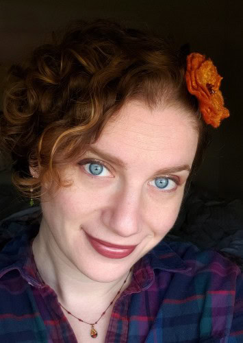 A picture of Alanna Wilcox with a felted flower in her hair