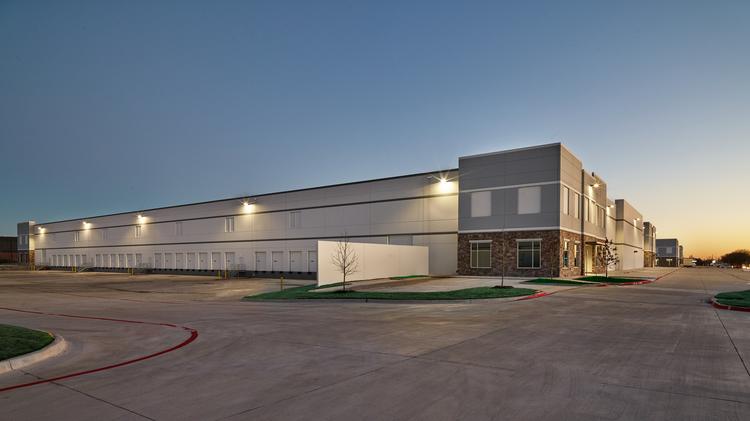Modern warehouse building at sunset.