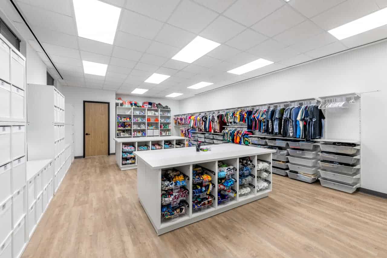 Organized storage room with clothes and supplies.
