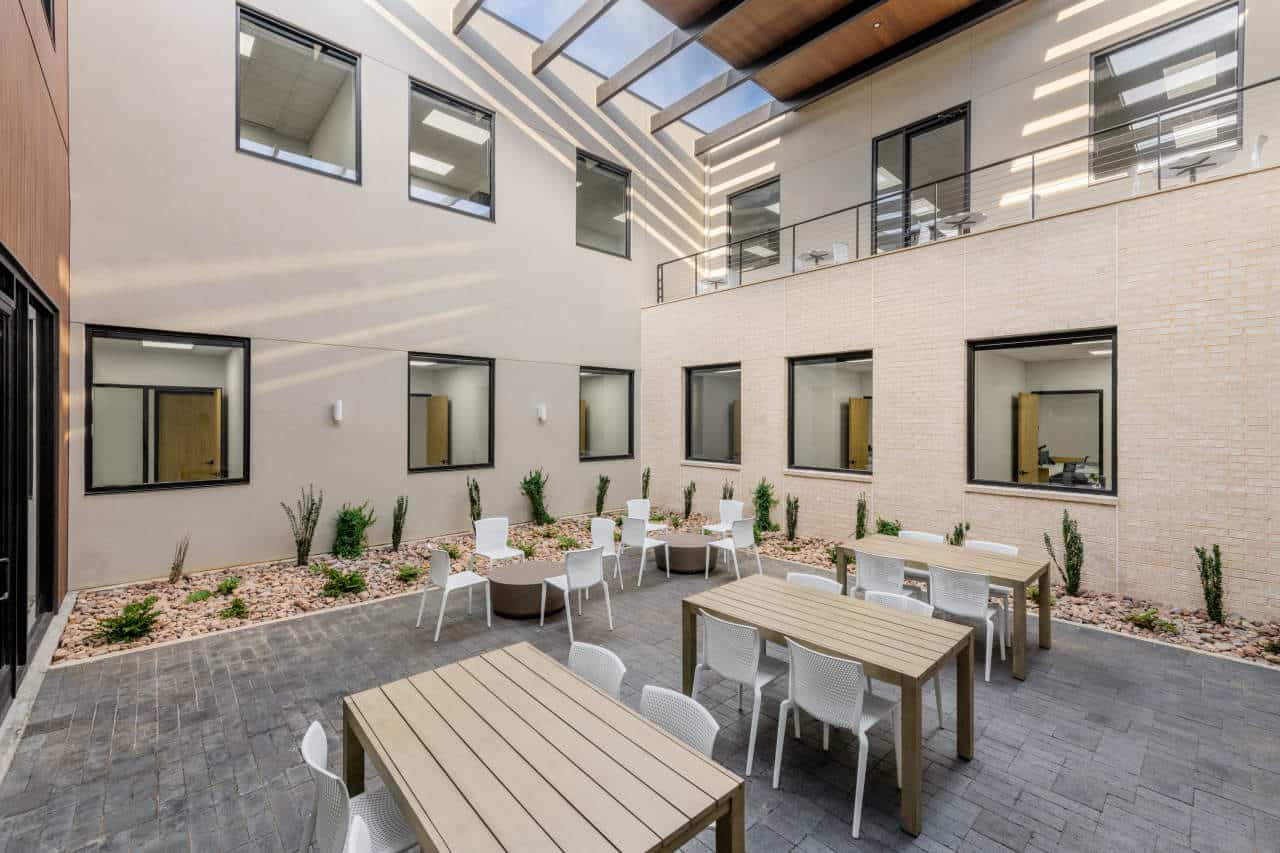 Modern courtyard with tables and white chairs