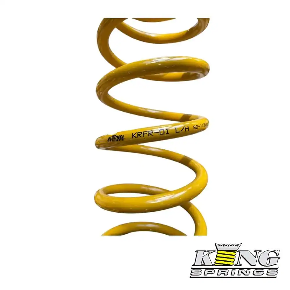Heavy-duty yellow coil spring shock absorber for industrial machinery.