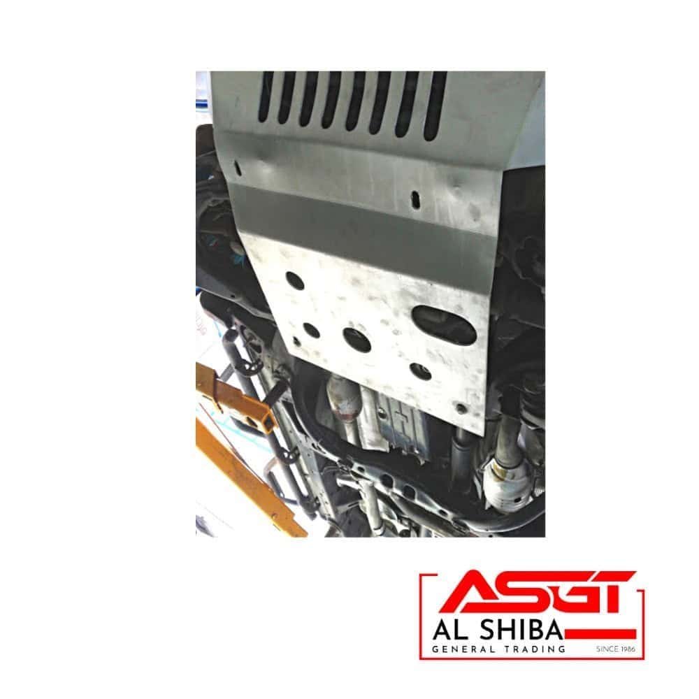 Protective metal skid plate on vehicle underside for durability and safety.